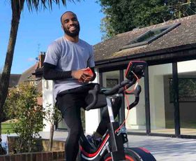 Photo: Alexandre Lacazette hits the exercise bike in his backyard