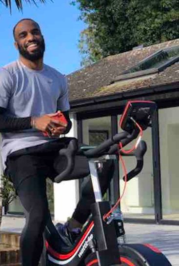 Photo: Alexandre Lacazette hits the exercise bike in his backyard
