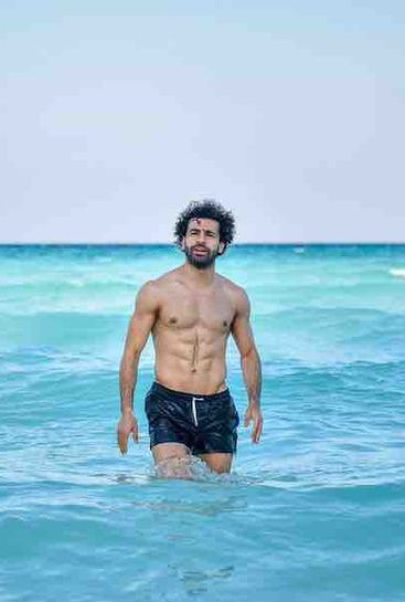 Photo: Topless Mo Salah wading in the sea on holiday
