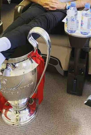 Photo: Jordan Henderson uses Champions League trophy as in-flight footrest