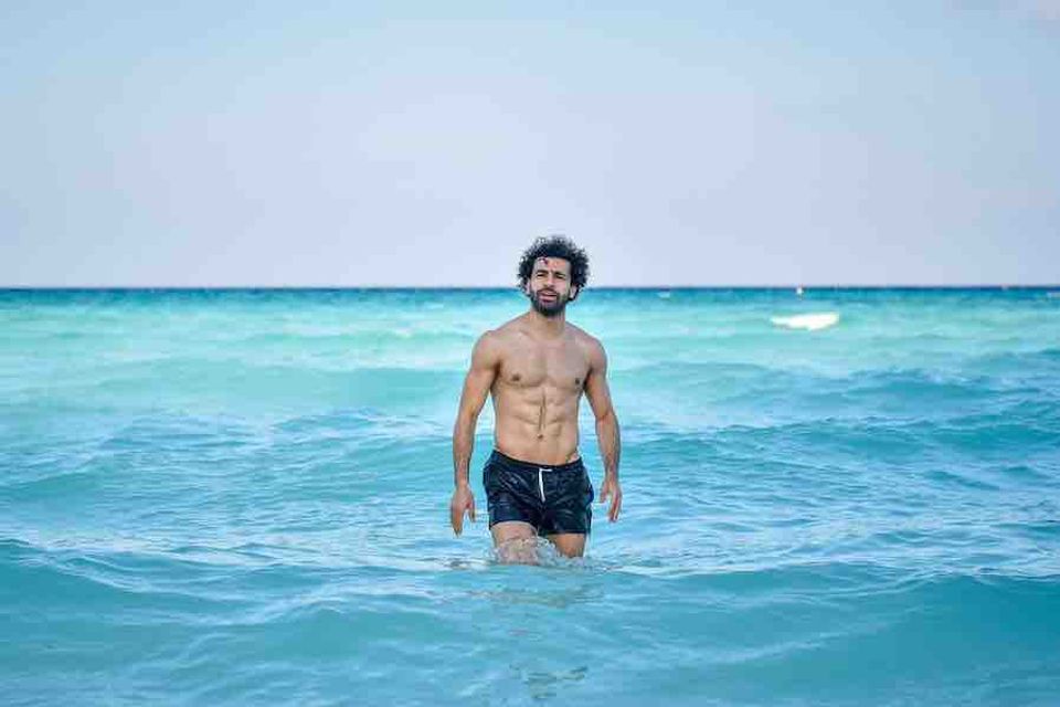 Photo: Topless Mo Salah wading in the sea on holiday