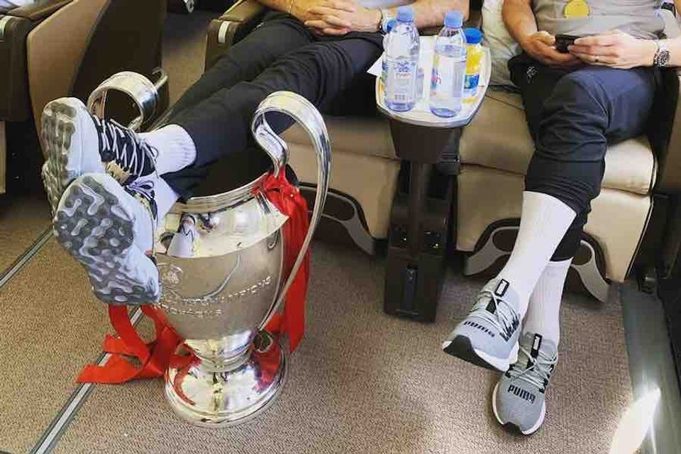 Photo: Jordan Henderson uses Champions League trophy as in-flight footrest